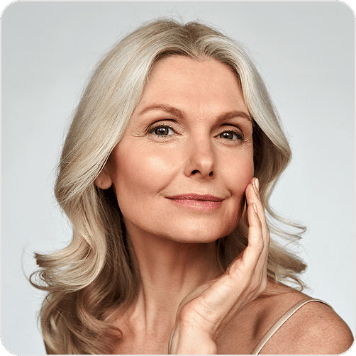 Older woman touching her face