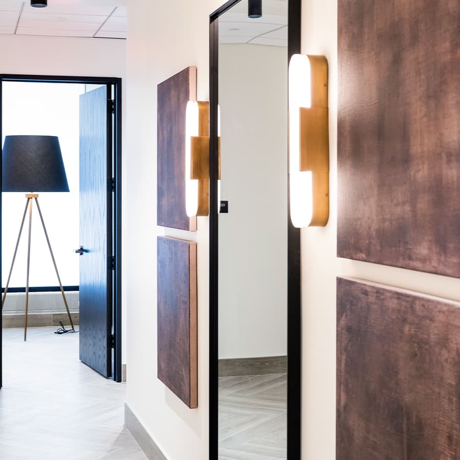 Clinic interior hallway with mirror and lamp